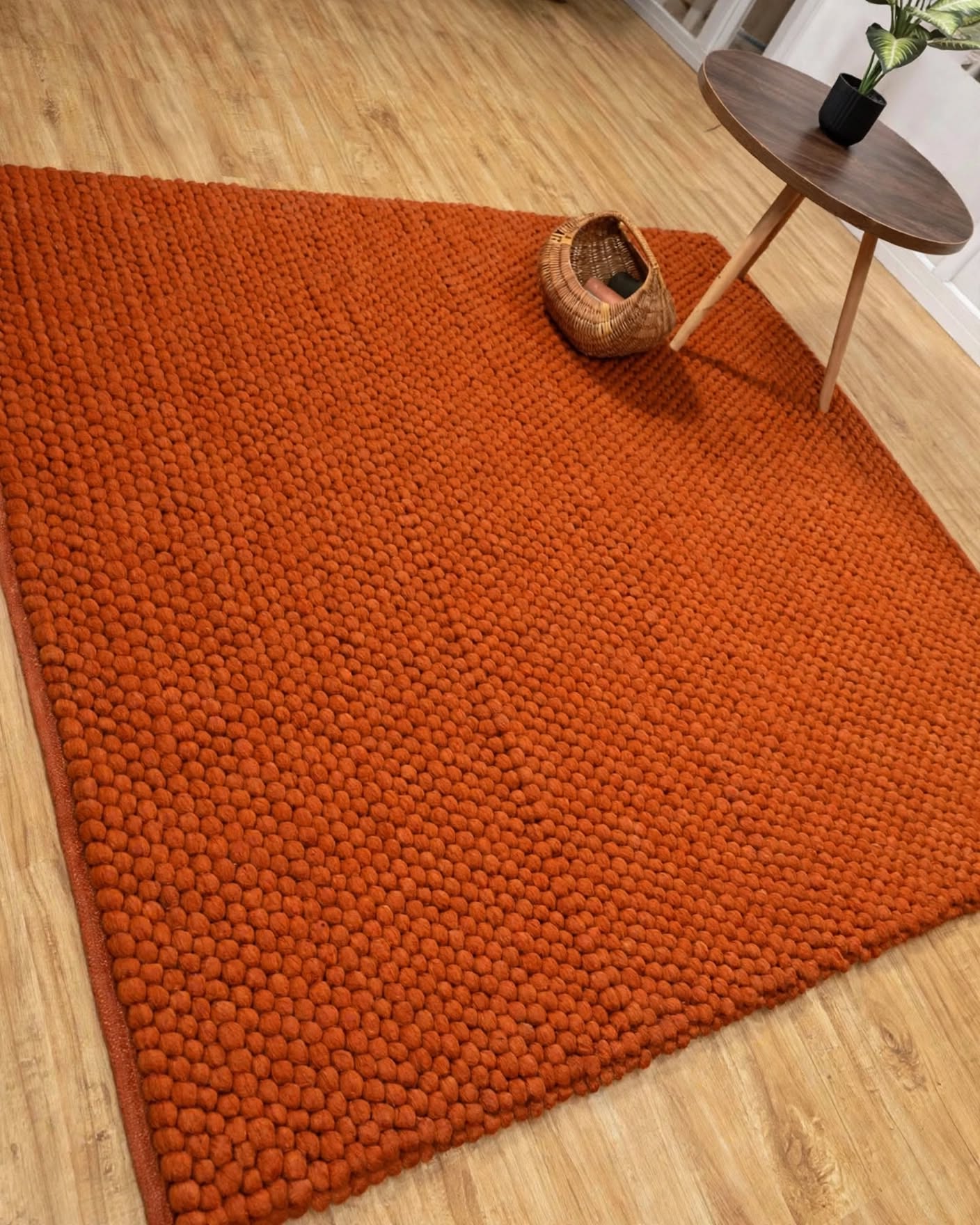 Terracotta Rust Chunky Wool Area Rug, handmade in Bhadohi India – a large rust-orange textured area rug with a chunky, looped tufted pattern,