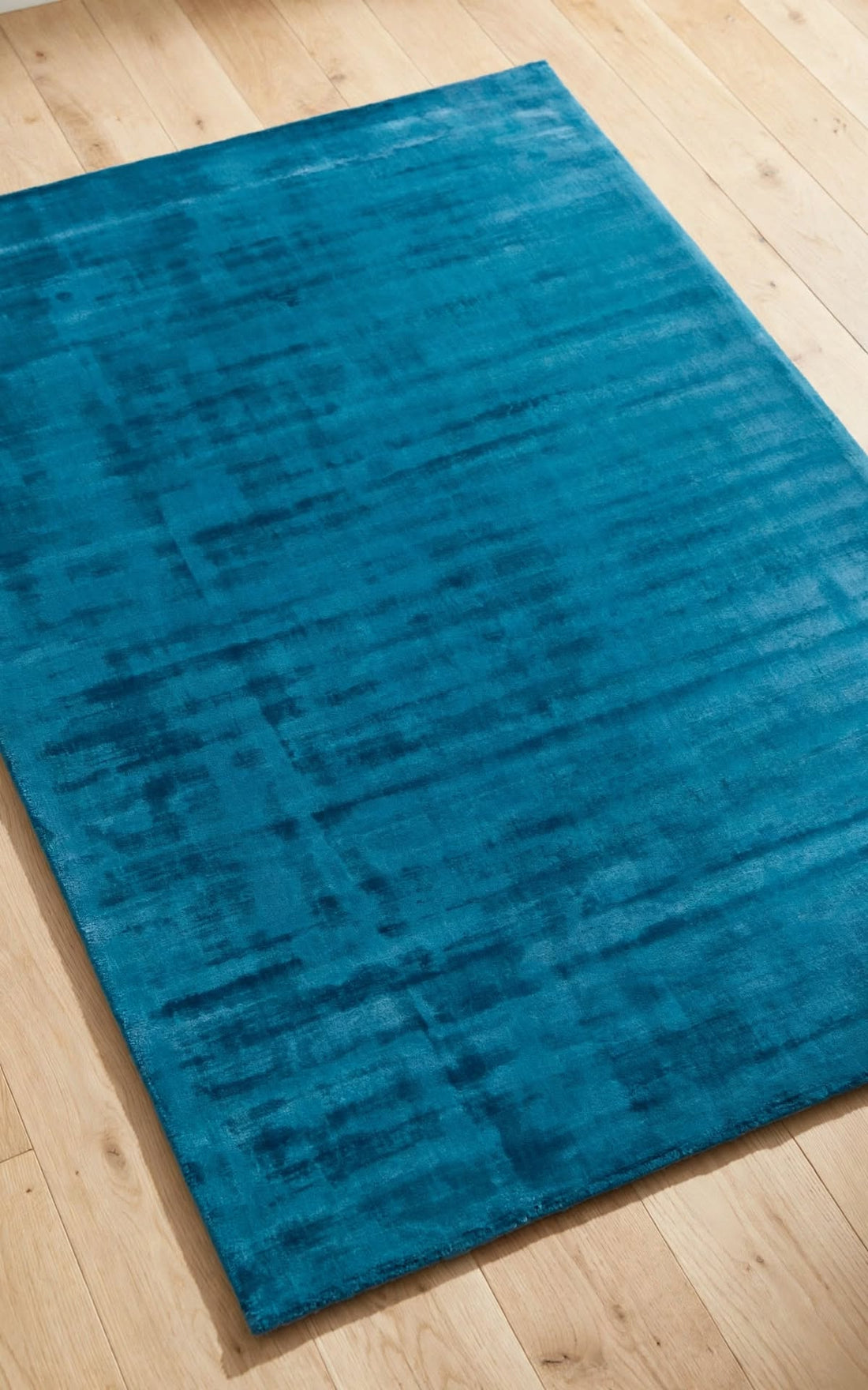 Blue Silky Viscose Rug, handmade in Bhadohi India – a rectangular blue area rug with a distressed, textured pattern, shown from an